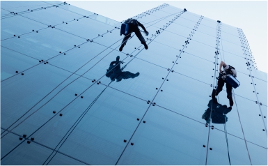 Two ACS Cleaning cleaners conduct facility cleaning